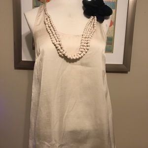 Beige top, with necklace and accent flower attach